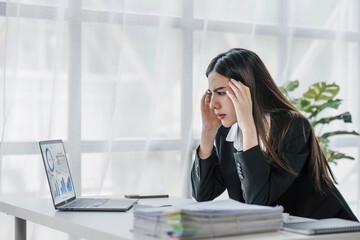 asian woman thinking hard concerned about online problem solution looking at laptop screen, worried serious asian businesswoman focused on solving difficult work computer task.
