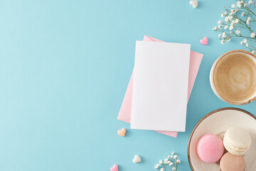 Top view photo of envelope with postcard cup of coffee plate with macaroons small hearts and gypsophila flowers on isolated pastel blue background with blank space. Mother's Day concept