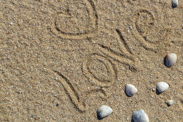 Fototapeta na wymiar love message written in sand, background for design