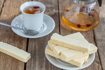 Tea party with sweet Russian waffles on a wooden background. Traditional sweets and dessert.
