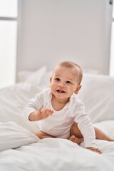 Adorable toddler smiling confident crawling on bed at bedroom