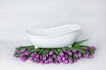 Fototapeta na wymiar baby bath with tulips. pink tulips. baby bath. purple flowers