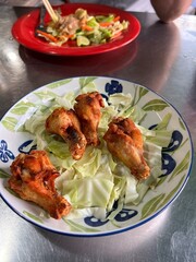 A plate of Thai Sweet Chicken with lettuce leaves at a local Thai Joint near the WAT PHO temple on the banks of the Chao Phraya River in Bangkok, Thailand