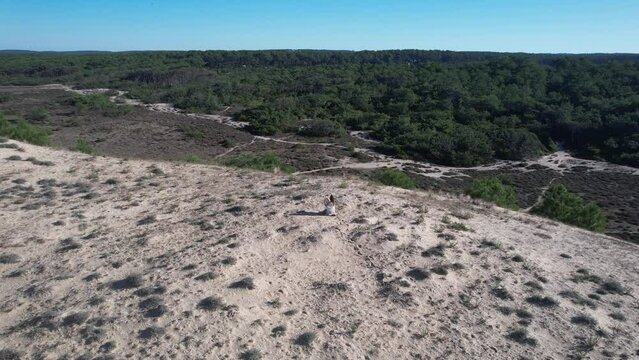 Beautiful spiral drone shot of a woman who plays the drum