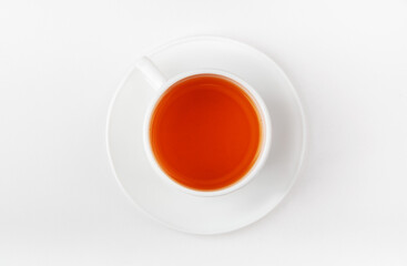 A white cup of tea on a white background. Morning black tea. Top view.