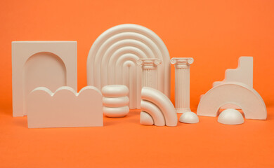 Gypsum geometric shapes for trendy product photography on an orange background