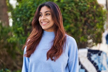 Fototapeta premium Young hispanic woman smiling confident standing at park