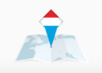 Luxembourg is depicted on a folded paper map and pinned location marker with flag of Luxembourg.