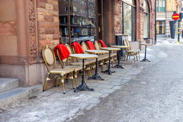Showcase of an old street cafe with tables and rare chairs in the center of Stockholm
