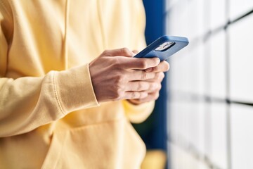 Young caucasian man using smartphone at home