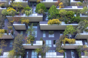 A close up view at the modern and ecological skyscrapers with many trees on each balcony. Bosco...