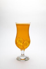Glass of beer with water droplets isolated on a white background.