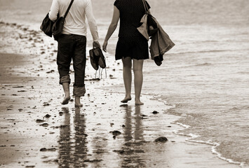 young couple barefoot at the seaside, sandy beach, Atlantic Ocean, Honfleur, Calvados, Normandy,...