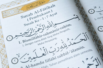 Prayer book open on the page containing Surah Al Fatihah of Holy Quran