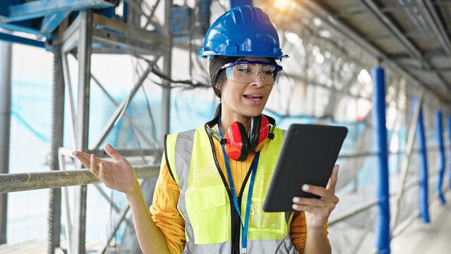 Young beautiful hispanic woman architect having video call at street - Powered by Adobe