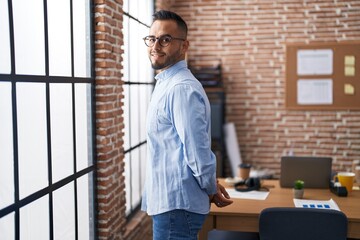 Young hispanic man business worker smiling confident standing at office