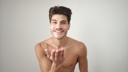 Fototapeta premium Young hispanic man smiling confident kissing over isolated white background