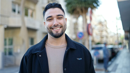 Young arab man smiling confident standing at street