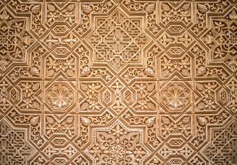 Nasrid Kufic poetic inscriptions in relief on the walls of the Alhambra in Granada, Spain