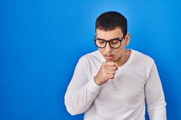 Young arab man wearing casual white shirt and glasses feeling unwell and coughing as symptom for cold or bronchitis. health care concept.
