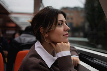 Young woman observing her surroundings during a boat canal tour in Amsterdam.