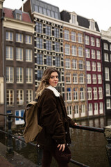 A girl wandering through streets of Amsterdam. As she walks among colorful buildings, bicycles, and local businesses, she has the opportunity to discover the historical and cultural features of city.