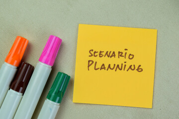 Concept of Scenario Planning write on sticky notes isolated on Wooden Table.