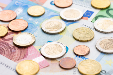 Assortment of Euro coins on Euro notes.