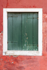 Obraz na płótnie Canvas Faded old rustic green wooden door from Venice Italy. The island of Burano tourist destination fishing island famous for it's coloured houses