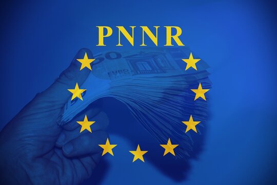 Money in hand with a flare with the European flag with banknotes and the text "PNRR" as background