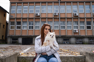 Red-haired young woman with her pomeranian