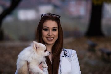 Portrait of a young woman with a Pomeranian