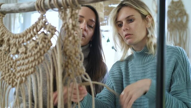 portrait of a friend learning to weave macrame for decor