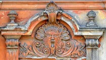 Evil face sculpture detail in architecture.