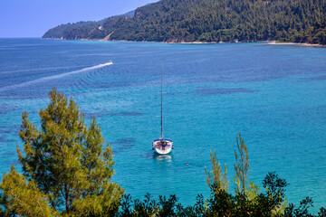 Sailing ship in the aegean sea near beautiful Fava sand beach near Vourvourou, Greek peninsula Sithonia, Chalkidiki
