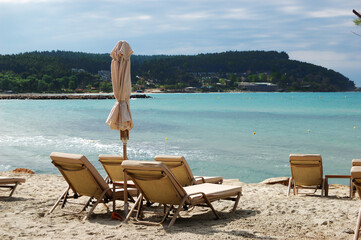 Sunbeds on a beach and turquoise water at the modern luxury hotel, Halkidiki, Greece