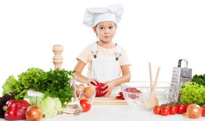 Portrait of adorable little girl preparing healthy food at kitchen