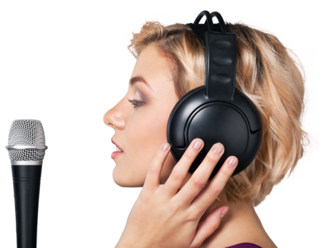 Woman Singing into a Microphone While Wearing Headphones