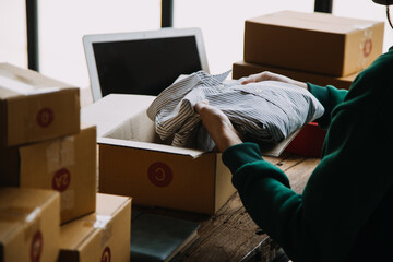 SME entrepreneur Small business entrepreneurs Online selling ideas,Happy Young Asian business owner work on computer and a boxs at home,delivery SME procurement package box deliver to customers,