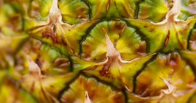 one ripe pineapple close-up, peeled pineapple peel green and yellow