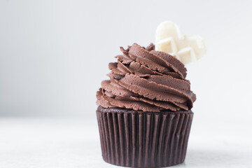 Chocolate cupcake with dark chocolate buttercream, double chocolate cupcakes with american buttercream, tall swirl frosting on a cupcake with a wafer
