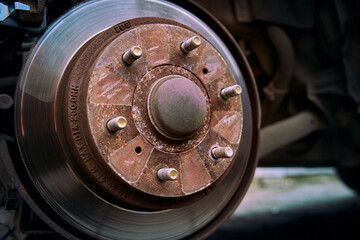 Close. up photo the rusty car brake rotor in automobile warckshop