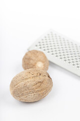 Nutmeg isolated. Whole nut and nutmeg powder isolated on white background.