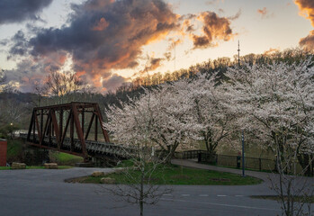 Old steel girder bridge carrying walking and cycling trail in Morgantown WV over Deckers Creek with...