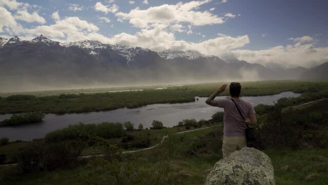 Caucasian man showing sense of freedom at breathtaking landscape in Glenorchy, Otago Region, New Zealand
