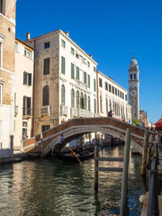 A gondola passes under a bridge in Rio di San Lorenzo, Venice