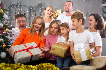 Portrait of happy family who is satisfied of presents in time celebration New Year in home