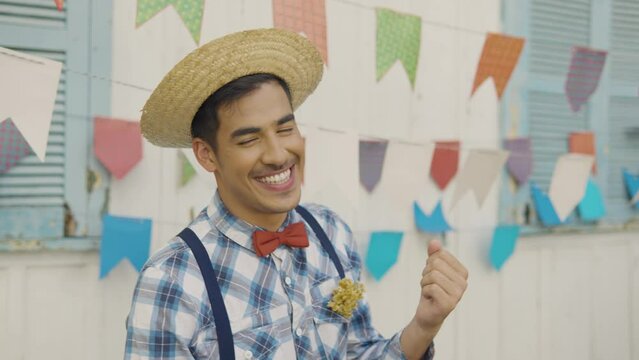 June Party in Brazil, happy man dancing at brazilian event wearing costume