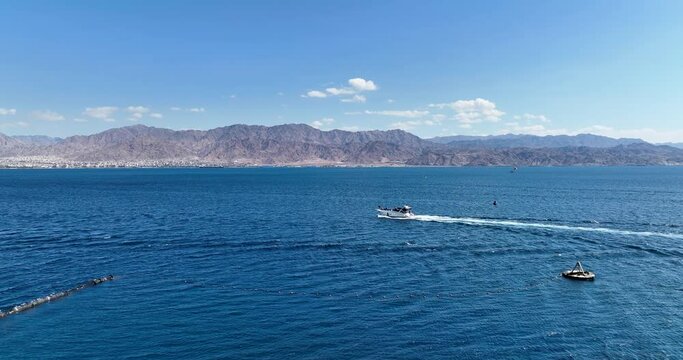 Aerial footage of a boat sailing in the Red Sea in Eilat. Filmed in C4K Apple ProRes 422 HQ