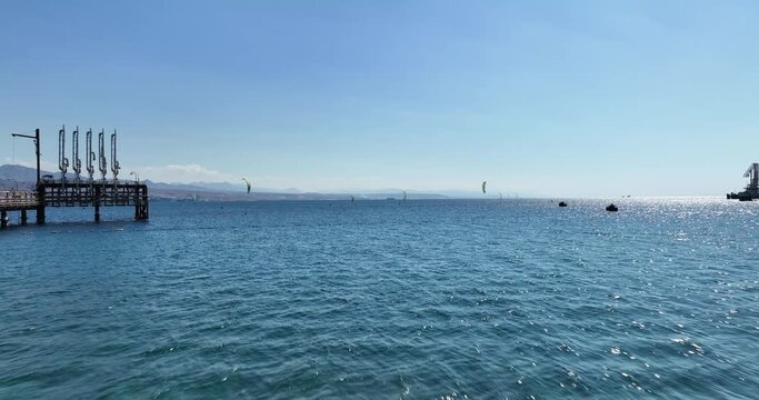 Aerial footage of professional kite surfers in front of the amazing beaches of Eilat.